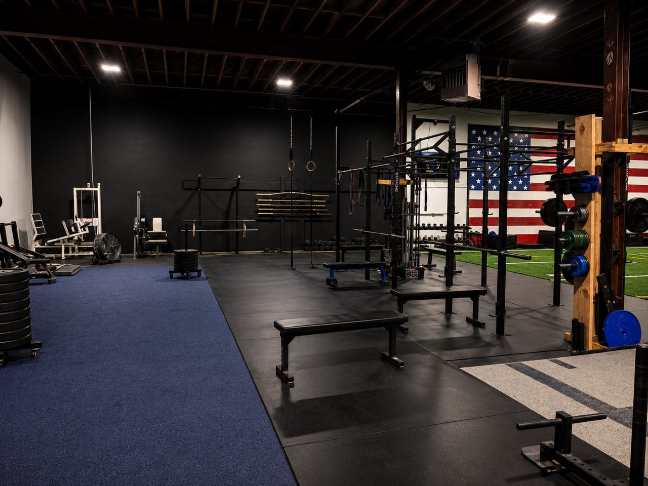 Fitness Academy strength training floor with racks and free weights